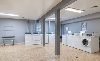 A laundry room with washers and dryers